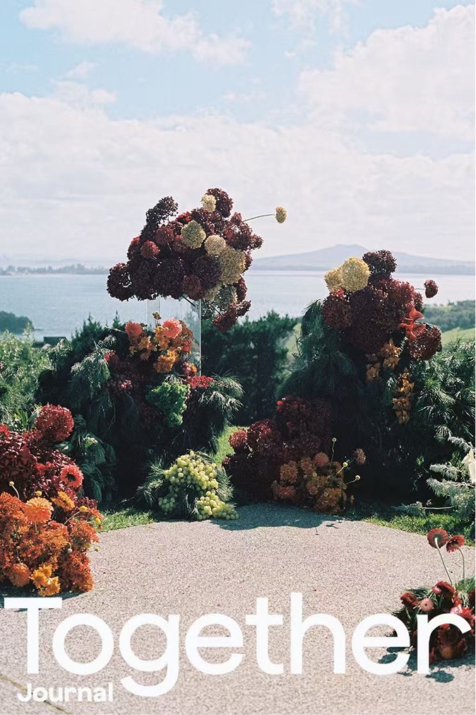 Together Journal cover: a suspended burgundy floral installation above the harbour